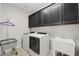 Convenient laundry room equipped with new washer, dryer, sink, and ample cabinet space at 216 Ocean Jasper Dr, Holly Springs, NC 27540