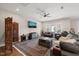 Spacious living room with plush seating, ceiling fan, large rug, and plenty of natural light at 216 Ocean Jasper Dr, Holly Springs, NC 27540