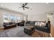Cozy living room featuring comfortable seating, a ceiling fan, and scenic outdoor views at 216 Ocean Jasper Dr, Holly Springs, NC 27540