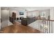 Upstairs living area featuring hardwood floors, railing, and an entertainment center at 216 Ocean Jasper Dr, Holly Springs, NC 27540