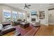 Bright living room featuring a fireplace, built-in shelves, and expansive windows offering scenic views at 216 Ocean Jasper Dr, Holly Springs, NC 27540