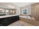 Luxurious main bathroom with soaking tub, walk-in shower, and dual vanity sinks at 216 Ocean Jasper Dr, Holly Springs, NC 27540