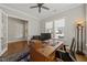 Well-lit home office featuring a ceiling fan and a classic wooden desk with ample workspace at 216 Ocean Jasper Dr, Holly Springs, NC 27540