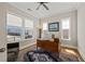 Bright home office with large windows, a ceiling fan, and a vintage desk at 216 Ocean Jasper Dr, Holly Springs, NC 27540