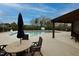 Community pool area with lounge chairs, tables, and pergola at 216 Ocean Jasper Dr, Holly Springs, NC 27540
