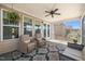 Inviting screened porch with comfortable seating, ceiling fan, rug and view of the backyard at 216 Ocean Jasper Dr, Holly Springs, NC 27540