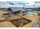 Community pool area with clubhouse, outdoor seating, and landscaped gardens on a sunny day at 217 Douglas Falls Dr, Wendell, NC 27591