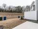 Spacious backyard with a partial fence, sloped hill, and patio at 2456 Tonoloway Dr, Raleigh, NC 27610