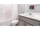 Bathroom with a white vanity, toilet, and a tub/shower with a curtain at 2456 Tonoloway Dr, Raleigh, NC 27610