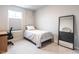 Bedroom with light grey carpet, a bed, a desk and a large mirror on the wall at 2456 Tonoloway Dr, Raleigh, NC 27610