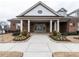 Clubhouse featuring brick, pillars, a sidewalk leading to the front doors and landscaping at 2456 Tonoloway Dr, Raleigh, NC 27610