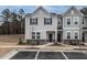 Charming townhome exterior featuring gray siding, stone accents, and well-manicured landscaping at 2456 Tonoloway Dr, Raleigh, NC 27610