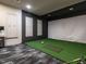 Golf simulator room with turf flooring and large screen for realistic play and practice at 2456 Tonoloway Dr, Raleigh, NC 27610