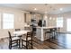 Bright open kitchen boasts stainless appliances, an island with bar seating, and modern pendant lighting at 2456 Tonoloway Dr, Raleigh, NC 27610