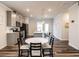 Bright kitchen with grey cabinets, island, and adjacent dining area at 2456 Tonoloway Dr, Raleigh, NC 27610