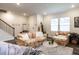 Cozy living room space with hardwood floors and staircase access at 2456 Tonoloway Dr, Raleigh, NC 27610