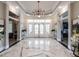 Bright lobby area with marble floors, statement lighting, and beautiful doors leading to outside at 2456 Tonoloway Dr, Raleigh, NC 27610