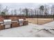 Outdoor kitchen with built-in grill, countertop, and a sand volleyball court in the background at 2456 Tonoloway Dr, Raleigh, NC 27610