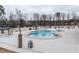 Community pool area surrounded by a white fence, trees, gazebos and lounge chairs to enjoy in the sun at 2456 Tonoloway Dr, Raleigh, NC 27610