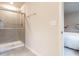 Bathroom shower featuring a glass door, showerhead, and mounted rack at 2456 Tonoloway Dr, Raleigh, NC 27610