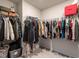 Walk-in closet features clothes hung on metal racks with items on the top shelf at 2456 Tonoloway Dr, Raleigh, NC 27610