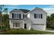 Charming two-story home featuring a manicured lawn, attached garage, and classic architectural details at 2605 Stonington Dr, Cary, NC 27523