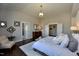Bright bedroom with vaulted ceiling, chandelier, brick accent wall, and ensuite bathroom at 263 Gilliland Rd, Siler City, NC 27344