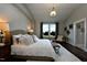 Cozy bedroom with brick accent wall, chandelier, and picturesque window view at 263 Gilliland Rd, Siler City, NC 27344