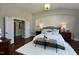 Well-lit bedroom with brick accent wall, chandelier, and ensuite bathroom at 263 Gilliland Rd, Siler City, NC 27344