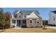 Beautiful two-story home with stone accents, a covered front porch, and manicured landscaping for a welcoming curb appeal at 263 Gilliland Rd, Siler City, NC 27344