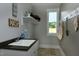 Functional laundry room with sink, storage, and natural light from the window at 263 Gilliland Rd, Siler City, NC 27344