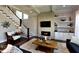 Inviting living room featuring a modern fireplace, built-in shelving, and coffered ceiling for a luxurious and cozy ambiance at 263 Gilliland Rd, Siler City, NC 27344