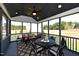 Relaxing screened porch with comfortable seating, a ceiling fan, and serene views of the surrounding landscape at 263 Gilliland Rd, Siler City, NC 27344