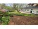Spacious backyard with a wooden deck and green space, offering privacy and outdoor enjoyment at 2704 Pidgeon Hill Rd, Raleigh, NC 27613