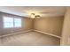 Cozy bedroom with neutral carpet, natural light, and a ceiling fan at 2704 Pidgeon Hill Rd, Raleigh, NC 27613