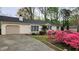 View of the exterior of a home with beautiful landscaping and a paved driveway at 2704 Pidgeon Hill Rd, Raleigh, NC 27613