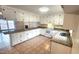 Well-lit kitchen with ample counter space and white cabinets at 2704 Pidgeon Hill Rd, Raleigh, NC 27613