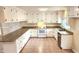 Bright kitchen with granite counters, white cabinetry, and stainless steel appliances at 2704 Pidgeon Hill Rd, Raleigh, NC 27613