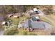 Expansive aerial view of home with pool, play set, garage, sheds, and ample land at 2746 Moss Creek Loop, Elon, NC 27244