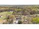 Aerial view of the property with pool, shed, garage, and circular driveway on large wooded lot at 2746 Moss Creek Loop, Elon, NC 27244