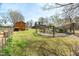 Expansive backyard featuring a shed, fenced garden, and ample green space for recreation at 2746 Moss Creek Loop, Elon, NC 27244
