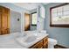 Full bathroom with wood cabinets and updated countertop at 2746 Moss Creek Loop, Elon, NC 27244