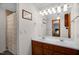 Bathroom featuring double sinks, wood cabinets, and a tub with a shower curtain at 2746 Moss Creek Loop, Elon, NC 27244