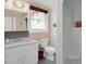 Bathroom features a white vanity, tiled backsplash, and a standing shower at 2746 Moss Creek Loop, Elon, NC 27244