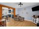 Living room showing hardwood floors and a partial view into the eat-in kitchen with an island at 2746 Moss Creek Loop, Elon, NC 27244