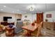 Cozy living room featuring a fireplace, comfortable seating, and dining area with a wooden table at 2746 Moss Creek Loop, Elon, NC 27244