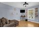 Cozy living room with hardwood floors, a ceiling fan and a comfy-looking sectional sofa at 2746 Moss Creek Loop, Elon, NC 27244