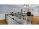 Spacious living room featuring a large sectional, hardwood floors, and soft, blue walls at 2746 Moss Creek Loop, Elon, NC 27244