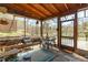 Relaxing sunroom with stone floor, wood beam ceiling, and natural views at 2746 Moss Creek Loop, Elon, NC 27244