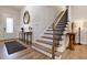 Inviting entryway with wood staircase, light floors, and elegant front door at 285 Gilliland Rd, Siler City, NC 27344